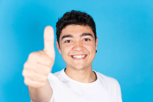 Hispanic Dark Positive Teenager Boy Thumbs Looking Camera Isolated Blue — Stockfoto