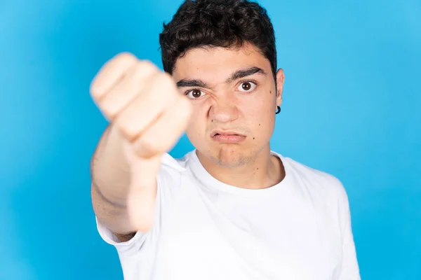 Sad Negative Hispanic Teenager Boy Thumbs Looking Camera Isolated Blue — Foto de Stock