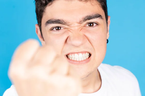 Angry Hispanic Teenager Boy Fist Menacing Looking Camera Isolated Blue — Foto de Stock