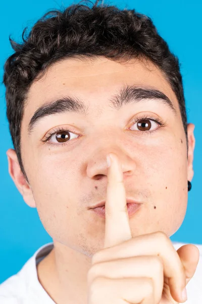 Hispanic Teenager Boy Asking Silence Looking Camera Isolated Blue Background — 스톡 사진