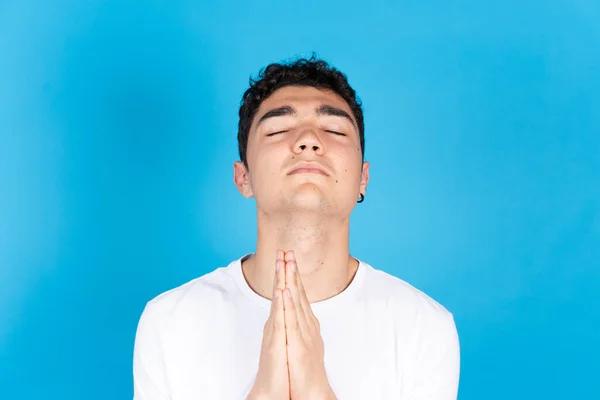 Portrait Hispanic Dark Teenager Boy Praying Looking Closed Eyes Isolated — Stok fotoğraf