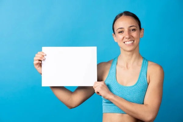Hispanic Sportswoman Showing White Paper Sheet Copy Space Isolated Blue — Fotografia de Stock