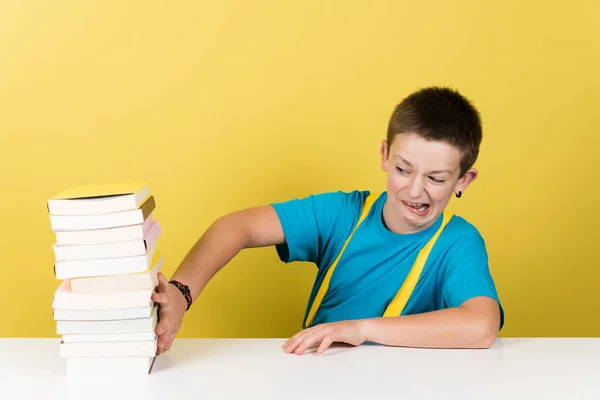 Schoolboy Nasty Face Rejecting Pile Books Isolated Yellow Background School — Stockfoto