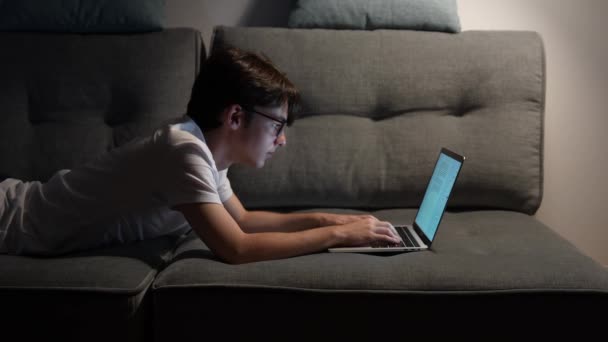 Teenager Boy Lying Couch Working Laptop Late Night Overworking Concept — Stock video