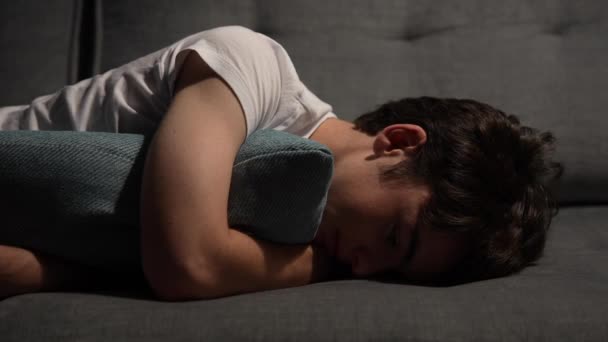 Teenager Boy Depression Anxiety Laying Couch Hugging Cushion Night — Video Stock