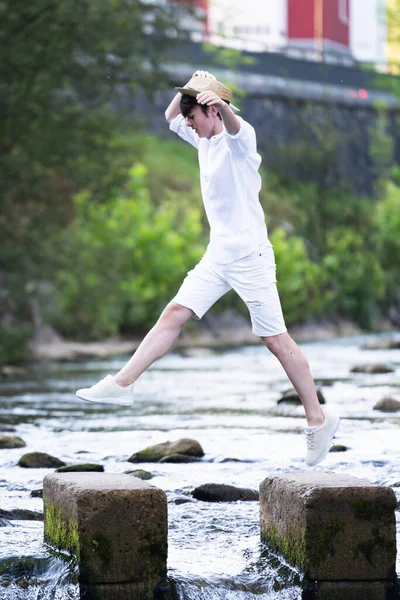 Handsome Teenager Boy Crossing River Jumping Park — Zdjęcie stockowe