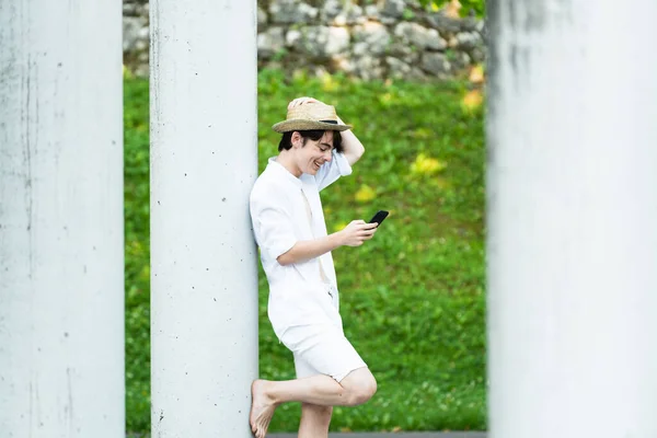 Cute Teenager Standing Using Phone Column Positive Boy Using Social —  Fotos de Stock