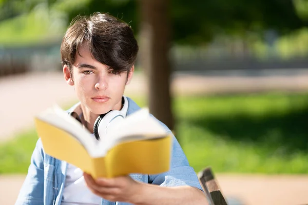 Closeup Portrait Cute Student Boy Looking Camera Holding Book Park — Fotografia de Stock