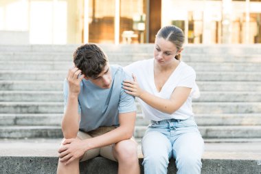Teenager girl comforting sad boy. Depression and anxiety assistance concept