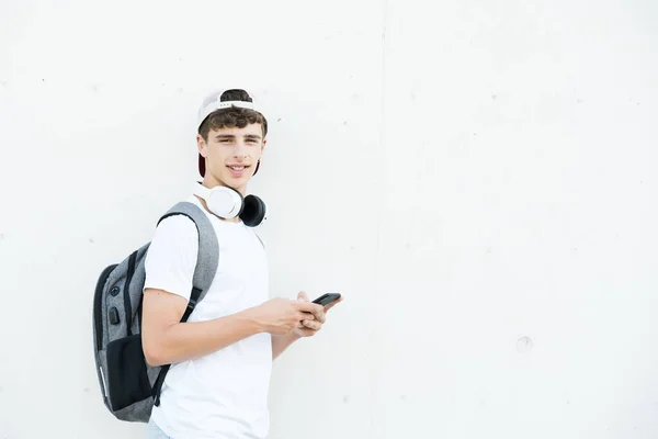 Handsome Teenager Student Boy Using Phone Looking Camera Concrete Wall — Stockfoto