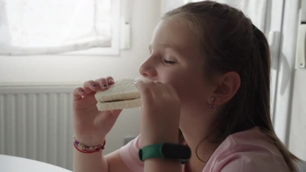 Cute Little Girl Eating Enjoying Chocolate Sandwich — Stock Video