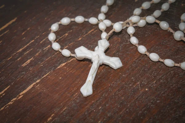 Religious cross on a wooden surface. Symbol of the Christian faith