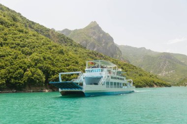 Fierza-Komani Ferry Stop in Komani Lake, Albania. Drin river, Albanian fjords with boat, ship, popular destination in Albania