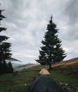 tent stand on a mountain range in the Carpathians at sunset