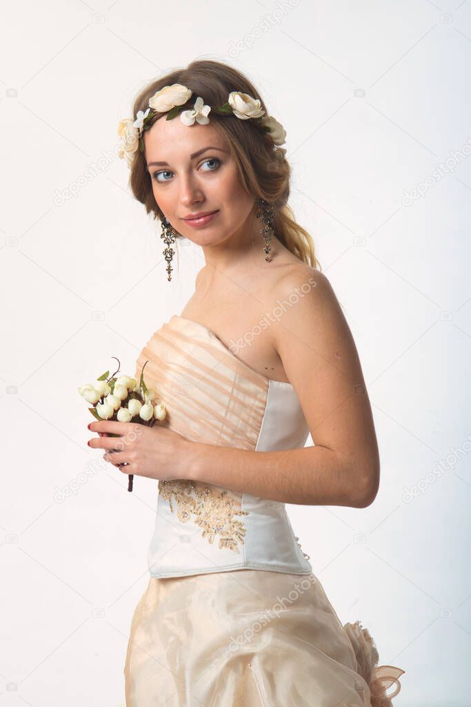 gentle girl bride in a wedding dress with a hairstyle 2021