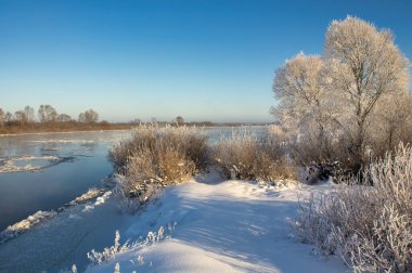 winter landscape. morning frost and sun. ice drift on the river. the branches of plants are covered with white frost 2022