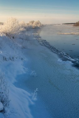 winter landscape. morning frost and sun. ice drift on the river. the branches of plants are covered with white frost 2022