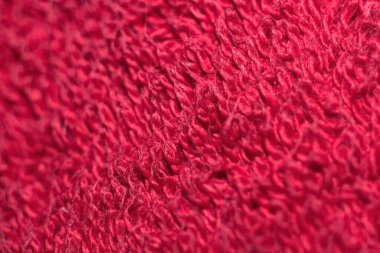 Close-up of red woolen fabric texture background. Macro of red wool texture.