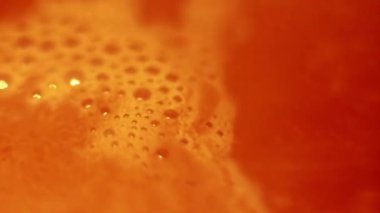 Foam with bubbles on the surface of boiling cocoa, high angle coffee close-up.