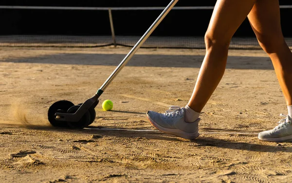 Preparation tennis clay court, cleaning and sweeping court markings.