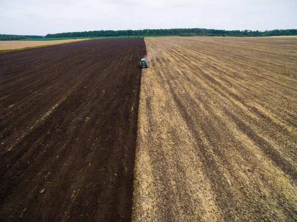 Harvesting in the field. Aerial view. Land cultivation with a tractor — Stock Photo, Image