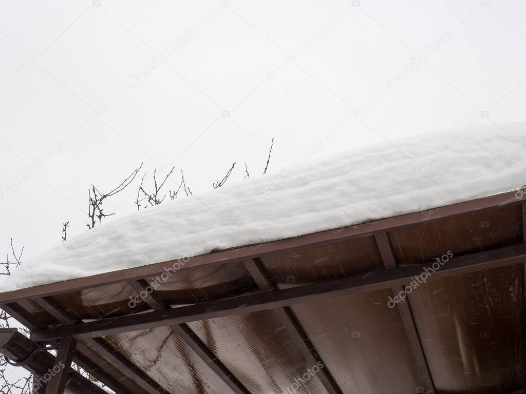 polycarbonate canopy roof under a pile of snow