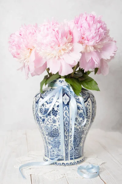 spring still life with bouquet of pink luxurious peonies in an ancient Chinese vase with blue ornament, High quality photo