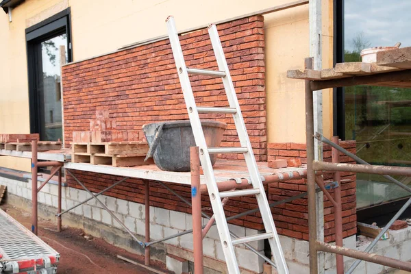 building a house supporting structure for laying bricks around a wooden base, a new House is being built, building materials, High quality photo