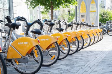 public yellow bicycles parked in the sharing on the street BRUSSELS, BELGIUM High quality photo