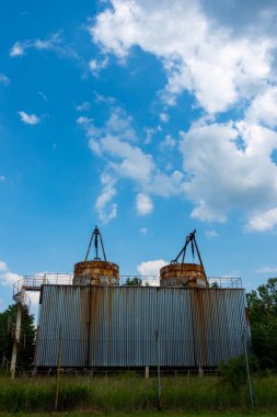 Terk edilmiş bir fabrikada soğutma kuleleri kapatılmış. Fotoğraf, güneşli bir günde çekilmiş..