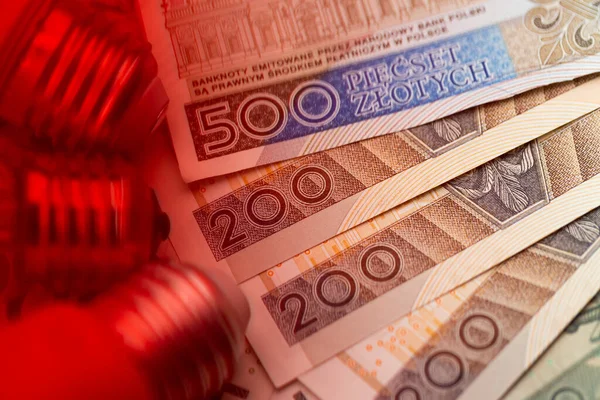 LED bulbs and many Polish banknotes. Rise of electricity price in Poland. Photo taken under artificial, soft light