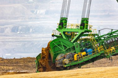 View of a giant excavator working on an opencast coal mine. Picture taken on a cloudy day, soft light. clipart