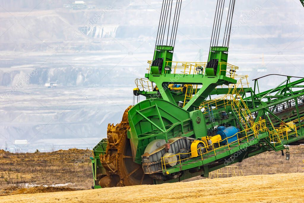 View of a giant excavator working on an opencast coal mine. Picture taken on a cloudy day, soft light.