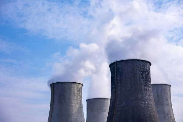 Close-up of steam coming out of the cooling towers of a coal-fired power plant. Photo taken on a sunny day, Contrast lighting.