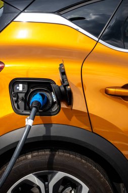 Close up for the socket of the electric car during charging. Modern electro mobility in everyday use. 
