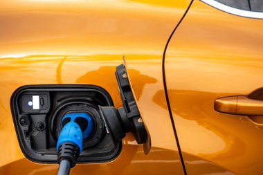 Close up for the socket of the electric car during charging. Modern electro mobility in everyday use. 