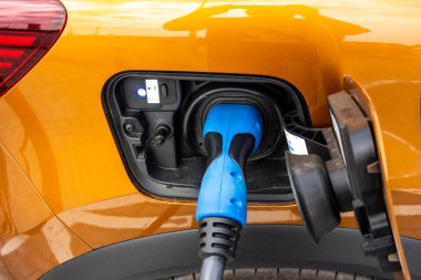 Close up for the socket of the electric car during charging. Modern electro mobility in everyday use. 