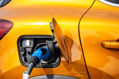 Close up for the socket of the electric car during charging. Modern electro mobility in everyday use. 