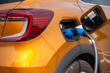 Close up for the socket of the electric car during charging. Modern electro mobility in everyday use. 