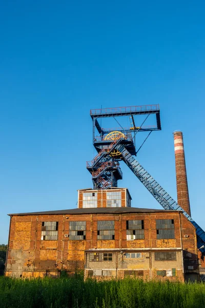 Distant view for the shaft tower of a closed black coal mine. Decarbonization processes in the modern world during the energy crisis