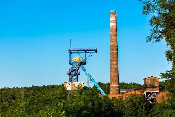 Distant view for the shaft tower of a closed black coal mine. Decarbonization processes in the modern world during the energy crisis