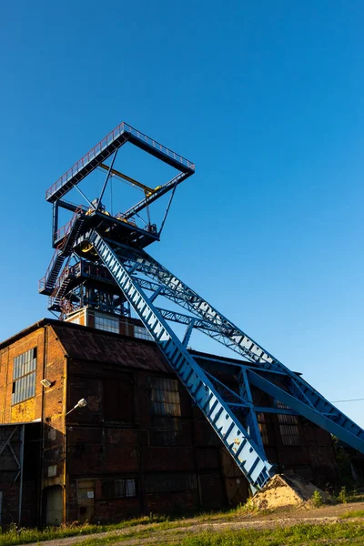 The shaft tower of a closed black coal mine. Decarbonization processes in the modern world during the energy crisis