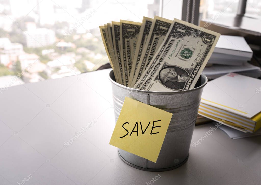 Some money  dollar bills in bucket for saving money  concept/selective focus