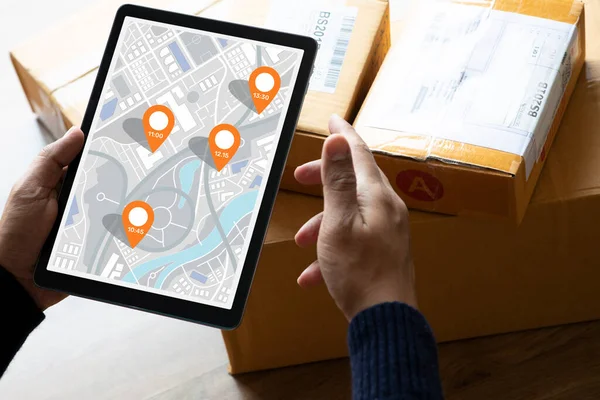 Delivery and online shopping concepts with young person using digital map with tablete on product package box.Ecommerce market.Transportation logistic.Business retail.
