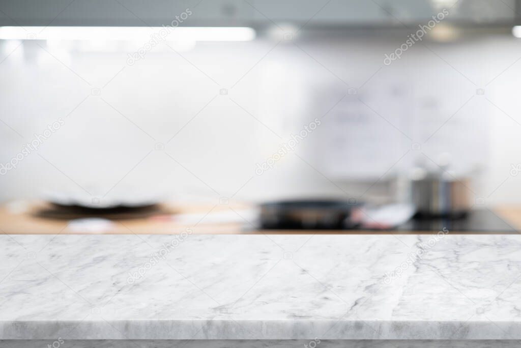 Selective focus,Marble table top on blur white kitchen room background.For montage product display or design key visual layout.