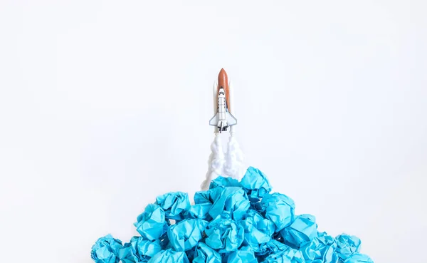 Ideas inspiration concepts with rocket and paper crumpled ball on white background.creativity of human