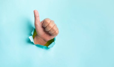Effect result concepts with hand showing thumb up on blue background.copy space