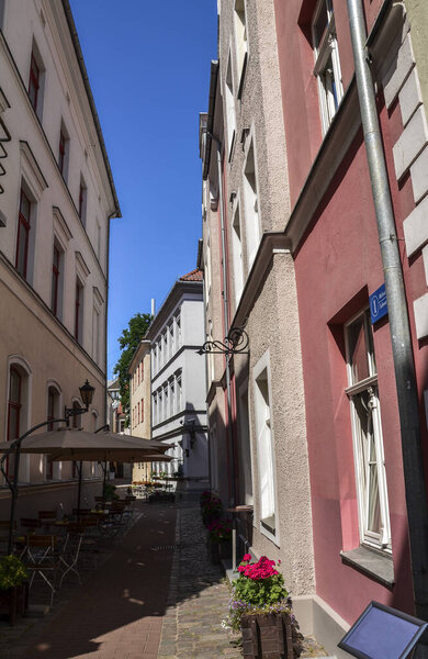 RIGA, LATVIA - JULY 26, 2014: One of the quiet narrow medieval street in in the historic center of old Riga, Latvia. Nice place to walk by