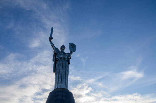 KYIV, UKRAINE - MARCH 25, 2021: Monumental statue The Motherland Monument against cloudy blue sky. The sculpture is a part of the National Museum of the History of Ukraine in the Second World War. Kyiv, Ukraine