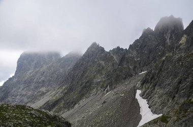 Bulutlu, yağmurlu, kayalık, yüksek Tatra dağlarının sisle kaplı manzarası. Slovakya 'daki doğal manzara
